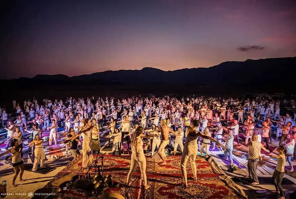 Dafna teaching yoga to a large group